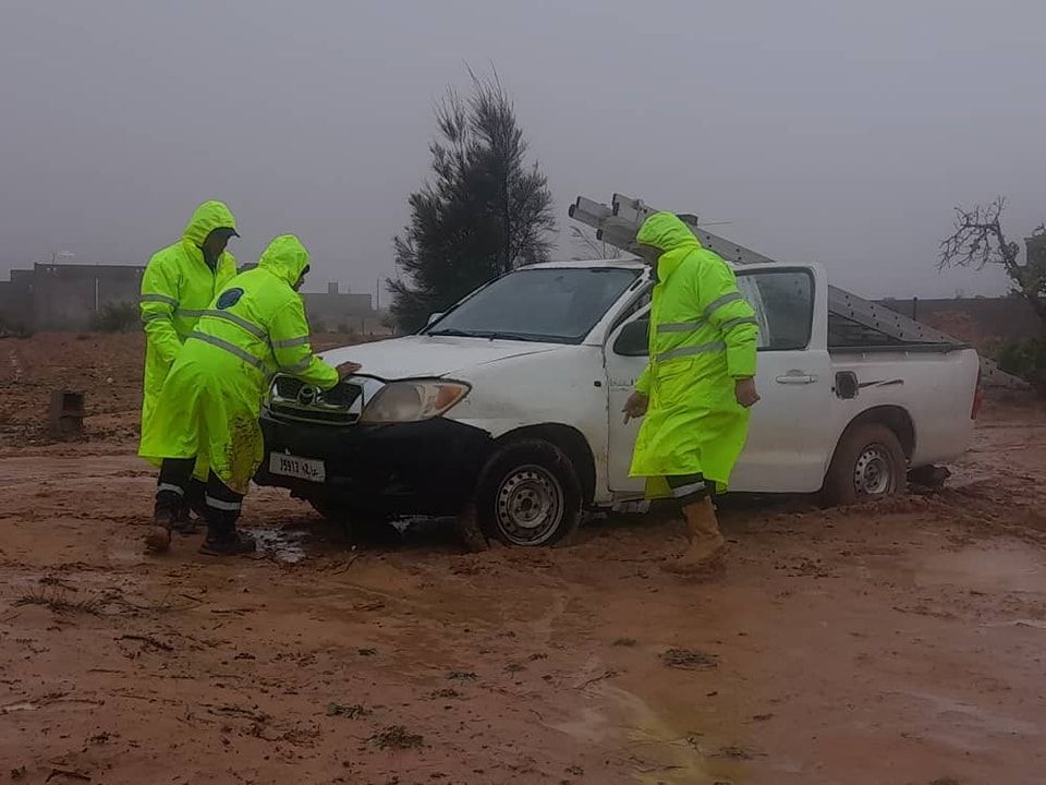 May be an image of 3 people, car and road